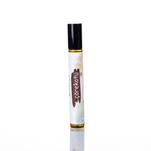 Amber çörekotu yağı roll-on tüpü, siyah kapaklı minimalist etiket.
